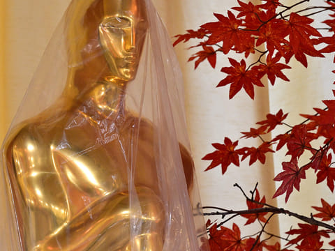 A decorative replica Oscar statue covered in protective plastic sheeting is seen as preparations are made on the red carpet arrivals area ahead of the 98th Annual Academy Awards in Hollywood, California, on March 13, 2026.