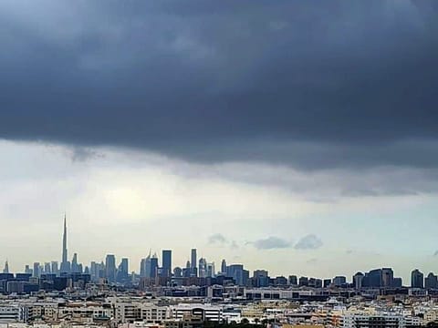A blanket of dark clouds covers Dubai’s skyline