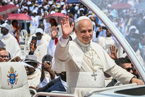 Pope Leo XIV waves to the crowd from the Popemobile as he arrives to lead the Holy Mass at the Saurimo esplanade in Saurimo on the eighth day of an 11-day apostolic journey to Africa, on April 20, 2026.