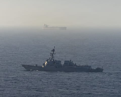 This US Navy handout photograph released on April 21, 2026, by US Central Command Public Affairs shows Arleigh Burke-class guided-missile destroyer USS Michael Murphy patrolling the Arabian Sea during a maritime blockade on April 15, 2026.