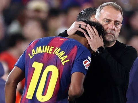 Barcelona's German coach Hans-Dieter Flick hugs Lamine Yamal as he is substituted due to injury