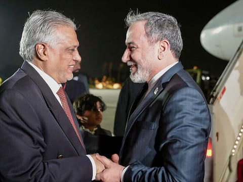 Pakistan’s Foreign Minister Ishaq Dar (L) greeting his Iranian counterpart Abbas Araghchi upon his arrival in Islamabad on April 24, 2026.