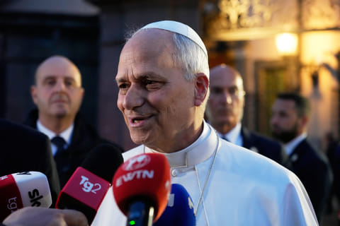 Pope Leo XIV talks to journalists as he leaves his residence in Castel Gandolfo, on the outskirts of Rome, to return to the Vatican
