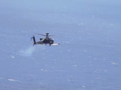 An Apache attack helicopter fires a "Hellfire" missile. On Monday, the US military said it destroyed six small boats in Hormuz area and intercepted Iranian cruise missiles and drones as Tehran sought to impose its toll system over the strait.