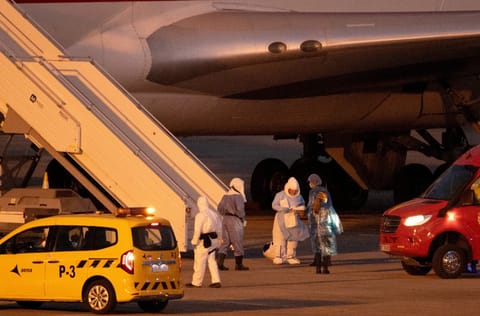 Passengers board a plane bound for US carrying passengers evacuated from the Dutch flagged hantavirus-stricken cruise ship MV Hondius at the Tenerife Sur-Reina Sofia airport on the island of Tenerife in Spain's Canary Islands on May 10, 2026.