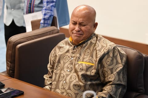 Philippine Senator Ronald dela Rosa reacts during a Senate plenary session on the third day of him holed up in the Senate building in Manila on May 13, 2026.