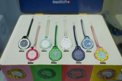 This photograph shows displayed watches of the Royal Pop collection through a glass window on the facade of a closed shop of Swiss watch company Swatch amid a promotional campaign for their watches in partnership with luxury swiss watch maker Audemars Piguet in Paris on May 16, 2026.