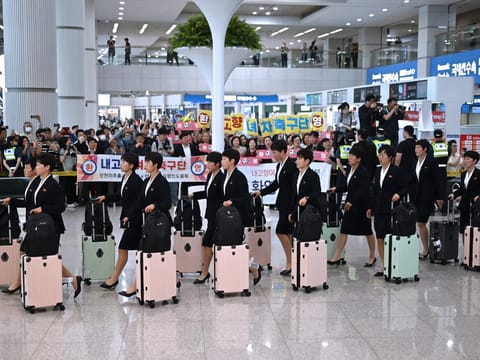 39 North Korean players and staff were greeted by supporters holding welcome signs upon arrival at the airport.