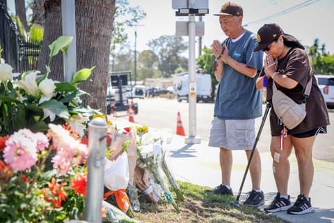 People pray at a makeshift memorial outside the Islamic Center of San Diego (ICSD) on May 19, 2026 in San Diego, California.