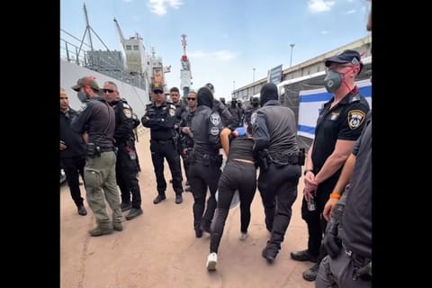 This screen grab taken from footage released on Israeli National Security Minister Itamar Ben Gvir’s X account on May 20, 2026 shows a detained activist from the Gaza-bound aid flotilla being escorted by security forces.