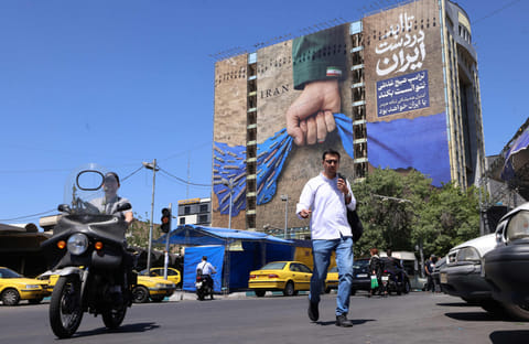 A billboard on the facade of a building depicting the Strait of Hormuz with a caption in Persian reading "Forever in Irans Hand", at Vanak Square in Tehran on May 25, 2026.