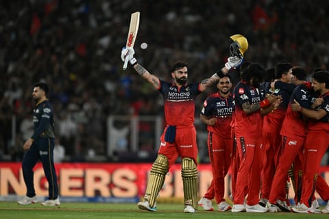 Royal Challengers Bengaluru's Indian cricket player Virat Kohli (C) celebrates with teammates after their team's win against Gujarat Titans at the end of the 2026 Indian Premier League (IPL) T20 final match in the Narendra Modi Stadium of Ahmedabad on May 31, 2026.