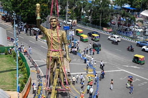 A crane lifts a giant statue of Argentine football legend Lionel Messi during its removal from a public installation site in Lake Town, Kolkata, West Bengal, on Monday, June 1, 2026. The statue was dismantled and taken down following concerns over its damaged condition and structural stability, which had raised public safety concerns.