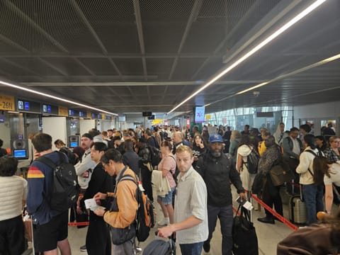 Passengers queue at immigration counters at Warsaw International Airport amid ongoing disruption linked to the EU’s new Entry/Exit System (EES), which has triggered long delays at several European airports.