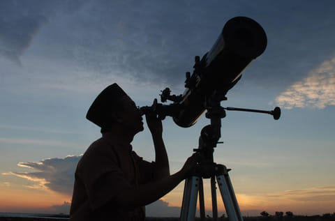 In this photograph taken on August 10, an official from the State Islamic University (STAIN), uses a telescope to observe the moon after sunset from the coast of Madura in East Java province of Indonesia on the eve of Ramadan. The exact dates of the start and the end of Islam's holy month Ramadan depend on the sighting of the new moon.