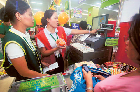 An employee tallies purchases at a store counter in Manila, Philippines. The Philippine peso is seen notching a third year of gains in 2021 as the sluggish economic recovery curbs imports and with remittances expected to rebound.