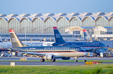 File photo: A US Airways Group Inc. Express Embraer 170 jet lands at Ronald Reagan National Airportin Arlington, Virginia, US.