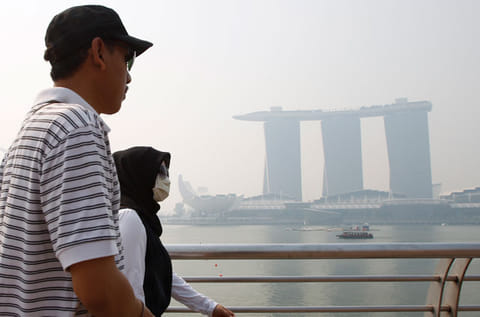 File picture of a tourist passing the Marina Bay Sands casino and resort in Singapore.