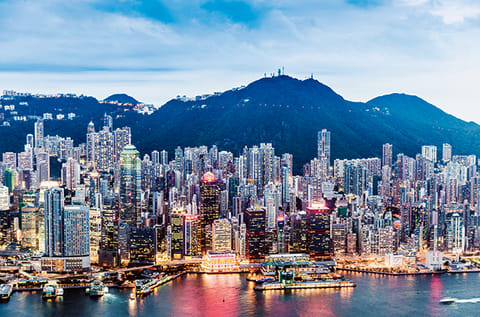 View of Victoria Harbour and Skyline in Hong Kong. Faced with a tax rate as high as 45% - up from about 15% previously - Chinese professionals across Hong Kong are considering moving back home to avoid getting squeezed by both the new levy and sky-high living costs.