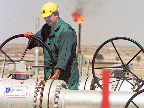 A worker of Kuwait Oil Company adjusts the flow of crude oil into a gathering centre. The cost of oil extraction is relatively less for the UAE, Saudi Arabia and Kuwait, where it is below the $16 per barrel mark.