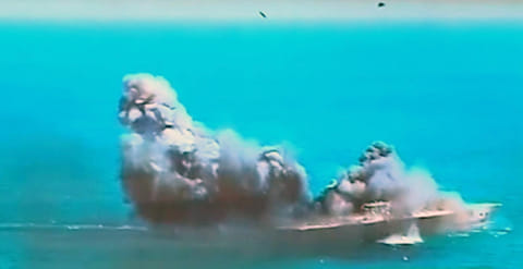 This image taken from Iranian state TV, shows damage to a mock US aircraft carrier during large-scale naval and air defence drills by Iran's Revolutionary Guard, near the Strait of Hormuz, Iran, in a file photo.