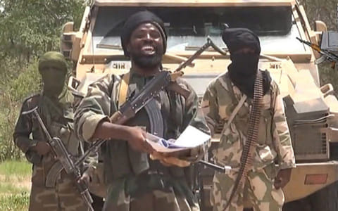 A screengrab taken on July 13, 2014 from a video released by extremist group Boko Haram and obtained by AFP shows the leader of the Nigerian Islamist extremist group Boko Haram, Abubakar Shekau (C).