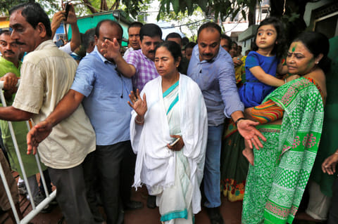 Mamata Banerjee, chief minister of the eastern Indian state of West Bengal and chief of Trinamool Congress (TMC), waves towards her supporters outside her residence after the initial poll results of the West Bengal Assembly elections, in Kolkata, India.