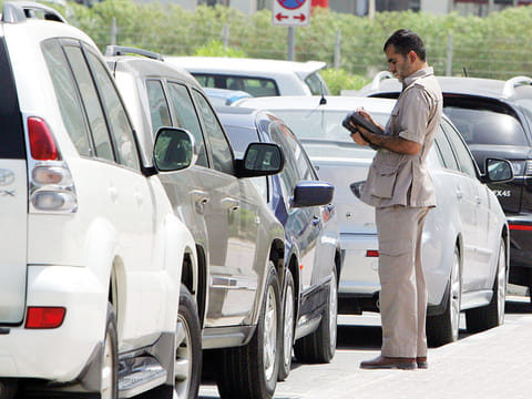 A RTA parking inspector issues fine to a vehicle in Al Safa area of Dubai.