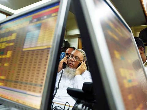 A stockbroker at the Karachi Stock Exchange. Global investors have piled $642.5 million into local-currency bonds this month alone.