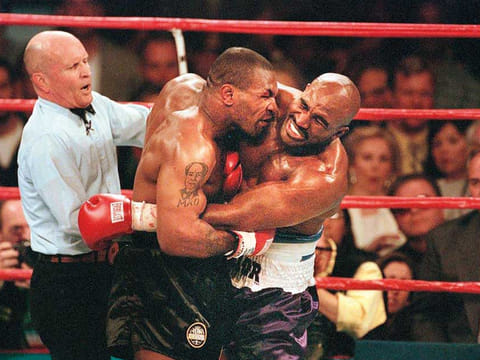 Referee Lane Mills stepping in as Evander Holyfield reacts after Mike Tyson bit his ear in the third round of their WBA Heavyweight Championship Fight at the MGM Grand Garden Arena in Las Vegas. -