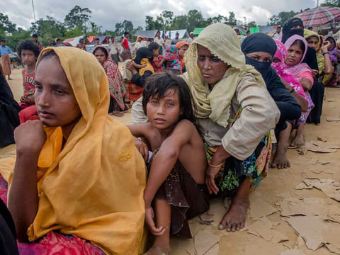 Rohingya Muslims, who recently crossed over from Myanmar into Bangladesh, wait for their turn to receive food aid near Balukhali refugee camp, Bangladesh, Friday, Sept. 15, 2017.