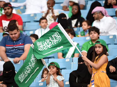 File picture: A Saudi girl waves the national flag in a stadium in the capital Riyadh.