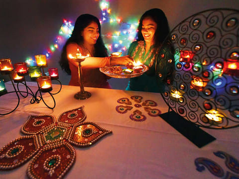 Saasha Bhatkal and her sister Sarisha decorate their home in Abu Dhabi with scented candles and traditional lighting.
