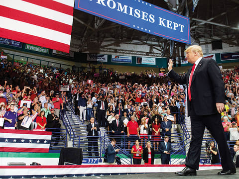 US President Donald Trump waves to the crowd during a campaign rally in Estero, Florida, for the US midterm elections. Both Trump, a Republican, and former president Barack Obama, a Democrat, are barnstorming the country ahead of the elections, in which Democrats hope to win control of the House of Representatives, gain Senate seats and pick up governor's mansions and state legislatures across America.