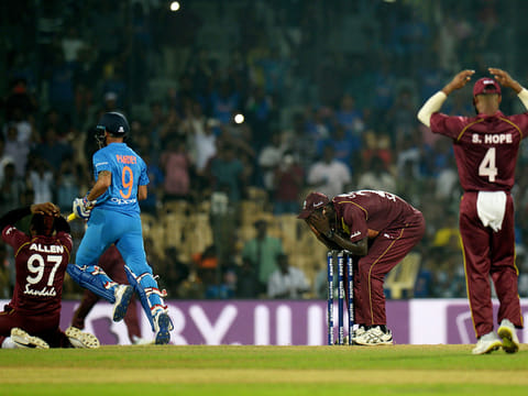 India's Manish Pandey runs across as West Indies cricketers reacts after loosing Third T20 cricket match at the MA Chidambaram Cricket Stadium in Chennai on November 11, 2018.