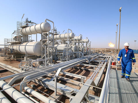 File photo: A worker walks at Rumaila oil field in Basra, Iraq.