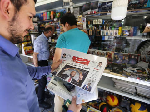A man looks at a newspaper with a picture of US President Donald Trump in Tehran. Washington announced on November 5 a series of sanctions targeting Iran’s banks, shipping sector, national airline and 200 individuals.