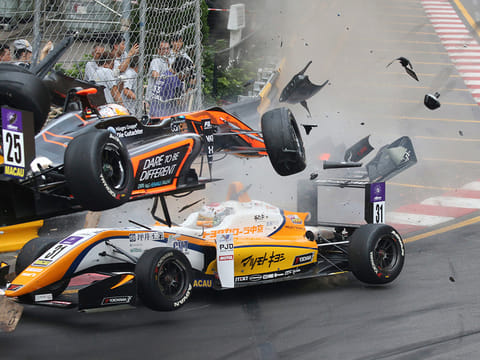 Teenage driver Sophia Floersch of Germany goes over Japanese driver Sho Tsuboi's car while flying off the track at high speed on a tight right-hand bend on lap four, in the Formula 3 Macau Grand Prix on Sunday.