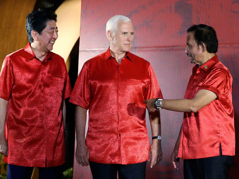 From left, Japanese Prime Minister Shinzo Abe, U.S. Vice President Mike Pence and Brunei's Sultan Hassanal Bolkiah talk before a family photo with leaders and their spouses during the APEC Economic Leaders Meeting summit in Port Moresby, Papua New Guinea