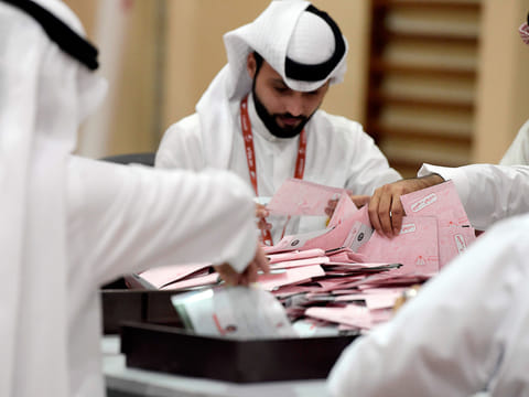 Election officials count ballots at a polling station in Sanad, south of the Bahraini capital Manama on December 1, 2018, following the end of Bahrain parliamentary and municipal elections.