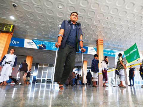 A wounded Al Houthi militiaman awaits his evacuation to the Omani capital Muscat at Sana’a International Airport
