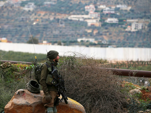 An Israeli soldier guards near the border with Lebanon, the morning after the Israeli military said it had launched an operation to "expose and thwart" cross-border attack tunnels from Lebanon