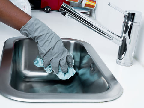 A maid cleaning the wash basin. For illustrative purposes only.
