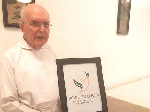 Fr. Gandolf Wild holding a framed message to the Pope.