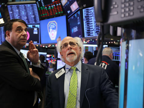 Traders work on the floor of the New York Stock Exchange (NYSE). Markets tumbled worldwide even as the US central bank rushed to plug the fiscal black hole formed by widespread panic among investors of a rapidly-spreading pandemic.
