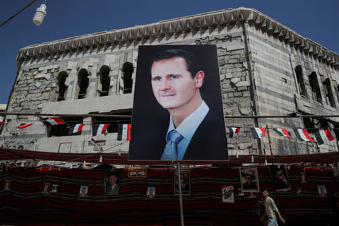 A giant banner portrays Syrian President Bashar Al Assad in Douma, outside Damascus.