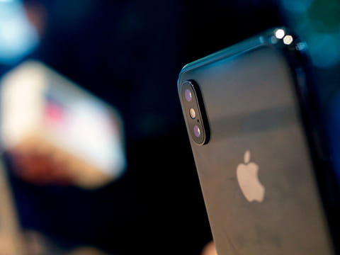 An Apple iPhone XS sits on display.