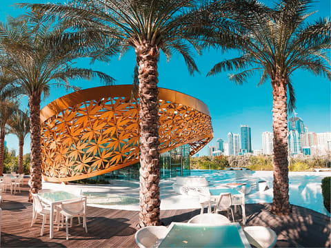 Sharjah’s skyline rises behind the butterfly garden on Al Noor Island
