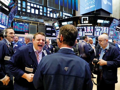 Traders at the New York Stock Exchange. With more companies worldwide reporting earnings in full swing, investors will keep an eye for how businesses are coping with the ongoing escalating crisis.