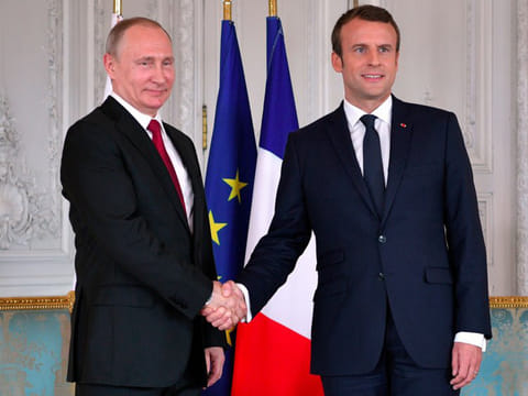 French President Emmanuel Macron with Russian President Vladimir Putin.